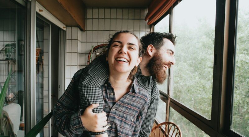 man and woman sitting on chair